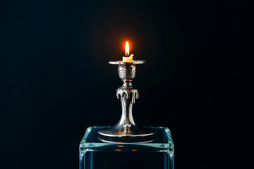 Glowing Candlelight on Silver Stand