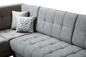 a close up of a beige sofa with tufted upholstery and neatly stitched square patterns.