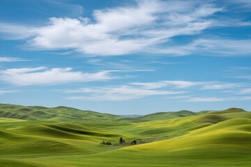 Obraz premium Lush green hills under a bright blue sky with fluffy clouds in a peaceful landscape during daylight hours