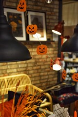 Halloween decor - small painted pumpkins hanging on a string