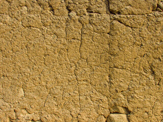 Rustic texture of handmade clay wall from ancient Peruvian architecture.