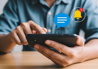 Person using a smartphone with notification icons showing message and bell alerts on the screen