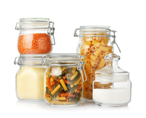 Glass jars with different products isolated on white