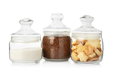 Glass jars with different products isolated on white