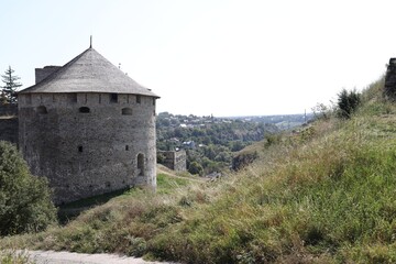 View of old stone tower on green hill