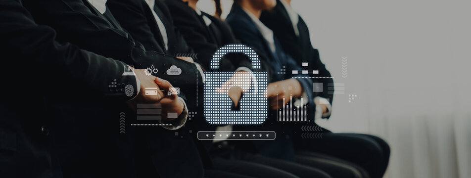 This image portrays a professional business meeting focused on cybersecurity and data privacy with modern technology elements and secure information concepts in the background. Trope