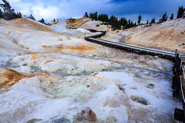 A boardwalk winds through the landscape of Bumpass Hell in Lassen Volcanic National Park, allowing...