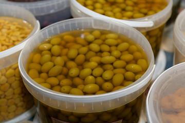 Containers of Marinated Green Olives on Display at a Market