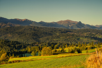 Łapszanka view point - warm colors, surrounding meadows, Giewont, and Czerwone Wierchy. Tatra (Tatry) Mountains. Golden hour 