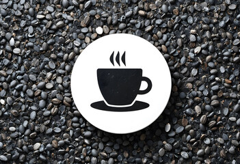 Black flat coffee cup icon inside white circle on coffee beans