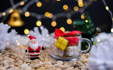 Festive Christmas Celebration: Miniature Santa Claus with Gift-Filled Mug & Sparkling Holiday Decorations