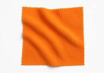 Crumpled microfiber cleaning cloth, isolated on white background. A folded micro fiber towel. Disinfecting tool.
