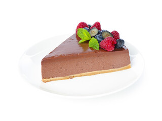 Piece of yummy chocolate cheesecake with berries isolated on white