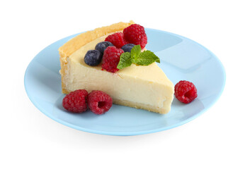 Piece of delicious cheesecake with fresh berries and mint isolated on white