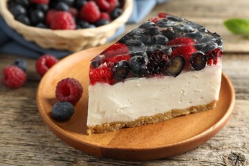 Piece of delicious cheesecake with berries on wooden table, closeup