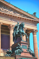 Equestrian statue in front of an ornate classical building