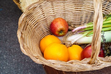 A colorful basket full of fresh, organically grown fruit and vegetables, a symbol of healthy eating and well-being.