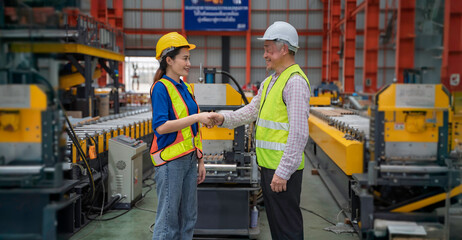 Engineer and technician inspecting materials on factory production line while discussing data on laptop. Great for industry, manufacturing, teamwork, and quality control concepts.