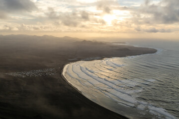 sunset over the volcanoes and coast of Timanfaya national park 
