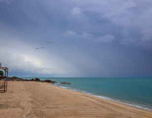 Beach with a cloudy sky and a small wooden structure
