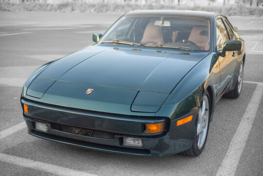 Airport City, Israel &ndash; 2025.09.26: Classic dark green Porsche 944 top frontal side view