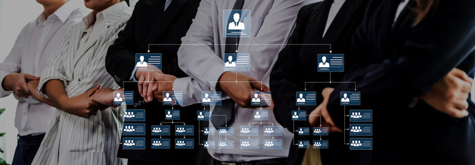 A diverse group of professionals stands together in a modern office setting, framing an organizational chart overlay that represents hierarchy and teamwork. Trope