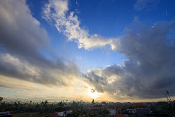 The sky is cloudy and the sun is setting