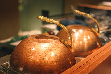 Traditional copper pan covers in a restaurant kitchen