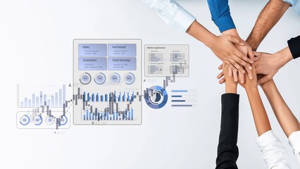 Obraz premium A diverse group of professionals uniting hands symbolize teamwork in achieving business goals, enhanced by digital metrics and analytics displayed on a modern workspace. Raster