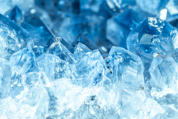 Blue Crystal Mineral Stone. Gems. Mineral crystals in the natural environment. Texture of precious and semiprecious stones. Seamless background with copy space colored shiny surface of precious stones