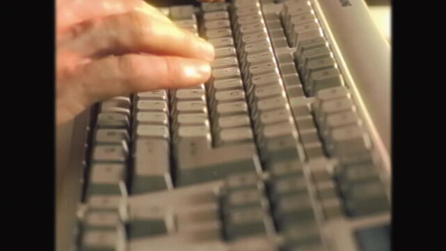 Retro 90s-2000s PC Keyboard Typing with Vintage VHS Effect. Nostalgic Hands on Old Computer Keyboard, Classic Technology Aesthetic, Grainy Cassette Video Style, Historical Computing Scene
