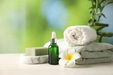 Beautiful spa composition with cosmetic product on white wooden table against blurred background, closeup