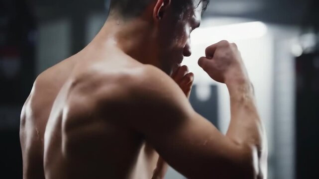 Strong man showing muscles in boxing stance for workout fitness
