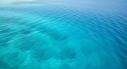 Crystal clear turquoise ocean water with gentle ripples and sunlight.
