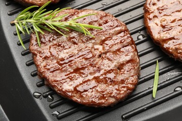 Pan with grilled patties and rosemary, top view