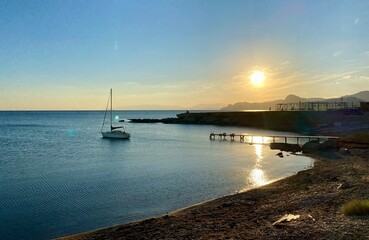 A beautiful view of a boat silhouette in the sea at sunset 