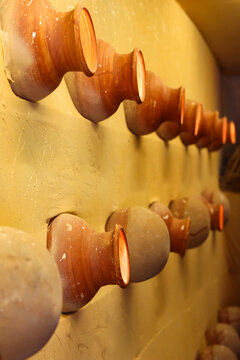 Traditional Pottery Wall Art: Rows of Clay Pots in Warm Indian Decor for Durga Puja Festival
