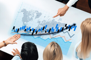 Professionals in a modern office setting analyze financial data on an innovative transparent screen, showcasing graphs and trends in collaborative discussion. Axiom