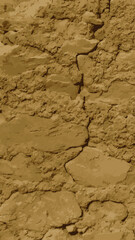 Textured Inca adobe wall with cracks.