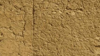 Cracked adobe wall ancient ruins background.