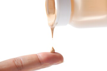 Close-up of a single drop of liquid foundation makeup on a fingertip, beauty and cosmetics concept