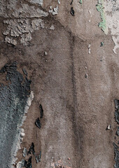 Close-up of old peeling paint on a wall surface. Weathered, cracked and flaking layers create a textured and distressed background.