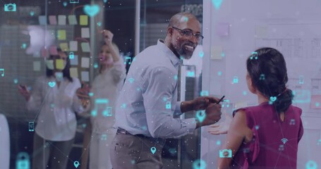 Business team mapping on whiteboard causing digital icons overlaying as presenter handing marker - Powered by Adobe