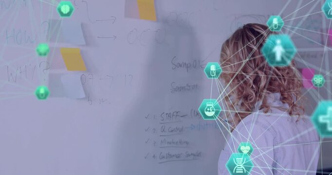 Teenage presenter writing bullet points on board as green hexagon network growing for education