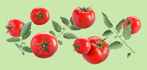 Fresh ripe tomatoes and leaves flying in air against light green background