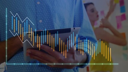 Man tapping tablet and updating translucent bars in tech office while coworker arranging notes - Powered by Adobe