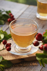 A cup of rose hip tea on a table outdoors
