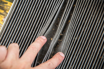 Old dirty carbon cabin filter of the car. Concept of replacement with a new one. Cleaning the air in the car cabin, close-up