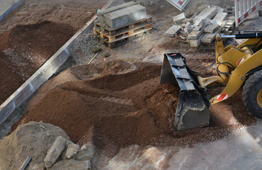 Excavator working on construction site moving soil