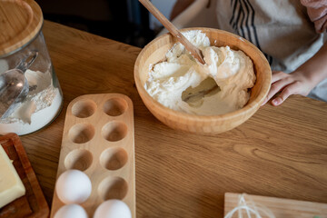 Little cute girl baking cookies in the kitchen. Homemade pastries. Cozy autumn.